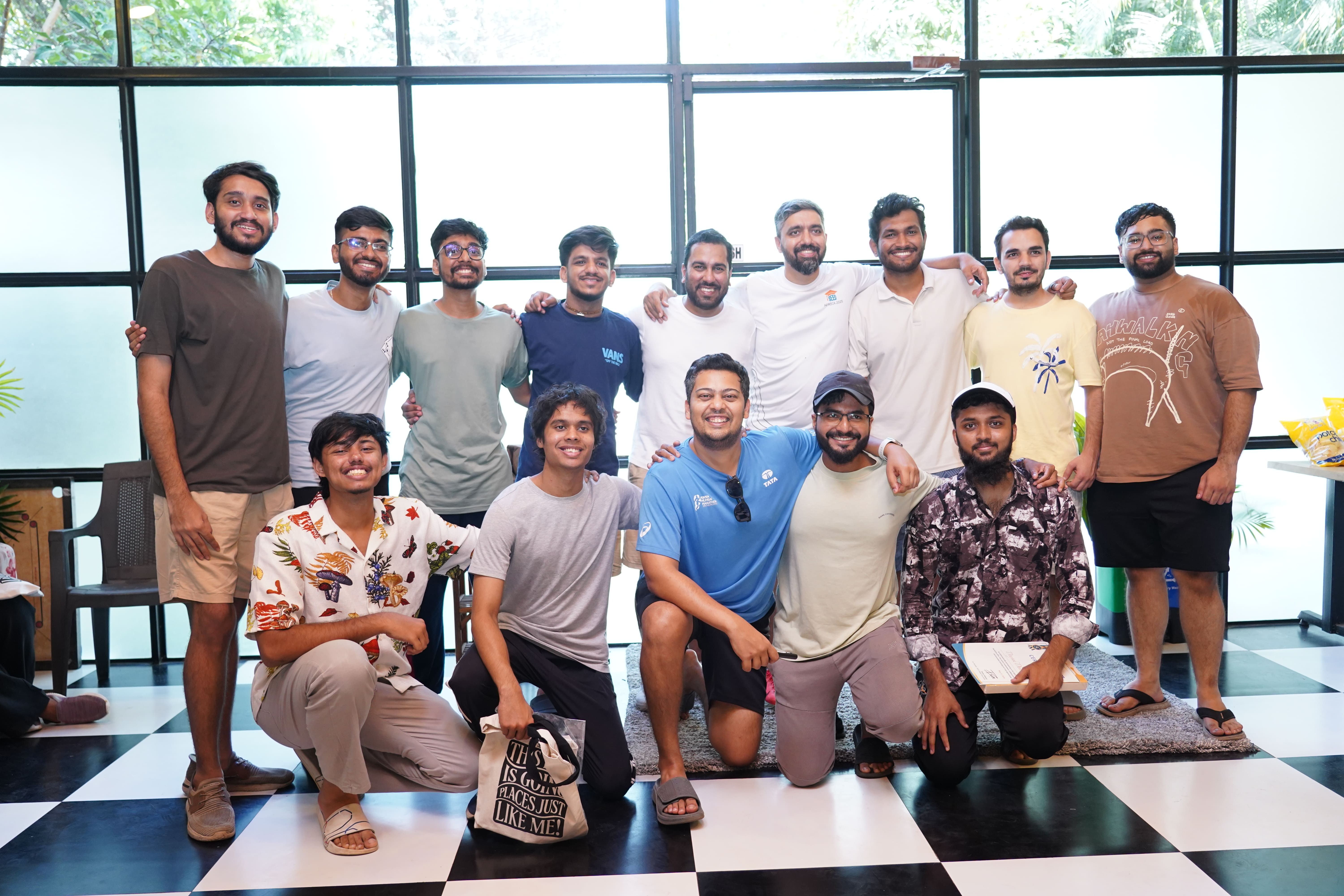 The SEED tech team, thirteen of them, grouped in front of tall windows